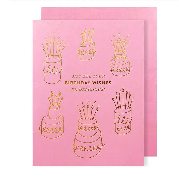 Pink card with gold foil, imprinted cake and text design on front. Text reads "May all your birthday wishes be delicious!" 