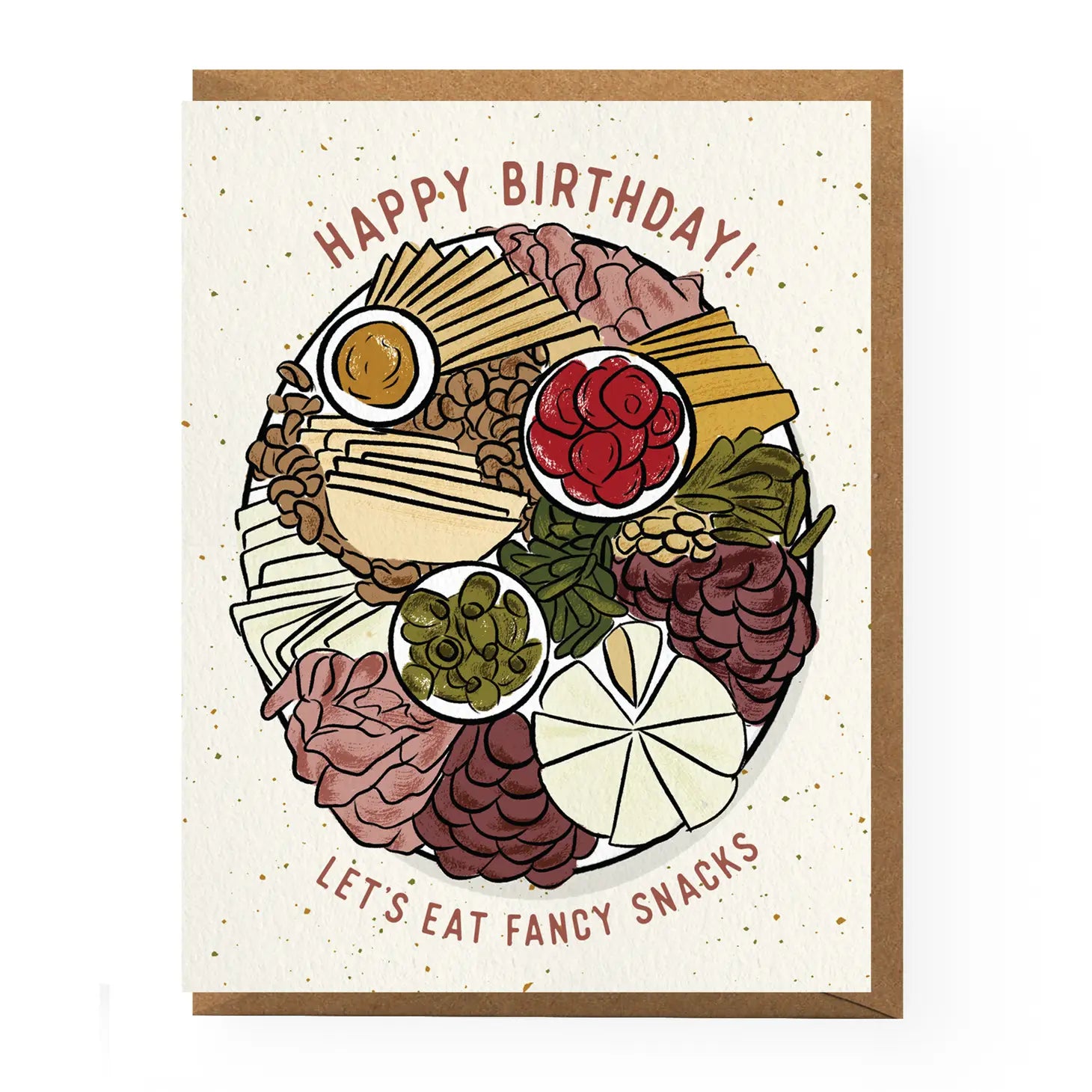 birthday card that reads "Happy Birthday!" at the top, above a round, illustrated picture of charcuterie board items, framed at the bottom with "let's eat fancy snacks" All on a speckled, white background with a brown envelope in between.