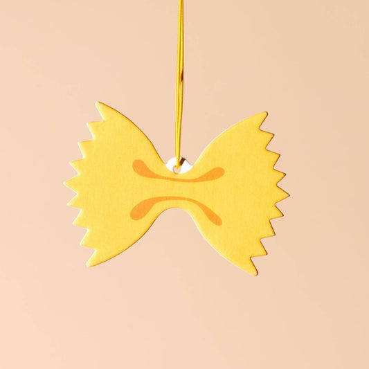 A car air freshener made to look like farfalle (bowtie) pasta. Lemon scented. 