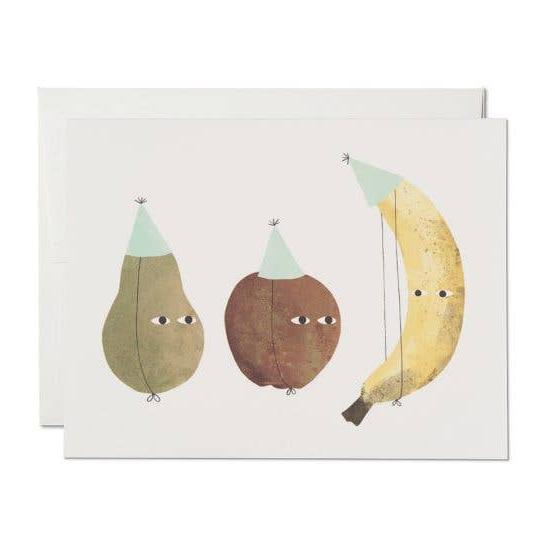 Greeting card with a pear, apple and banana wearing birthday hats 