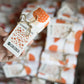 focused image of a rolled up mushroom tea towel with tag packaging 
