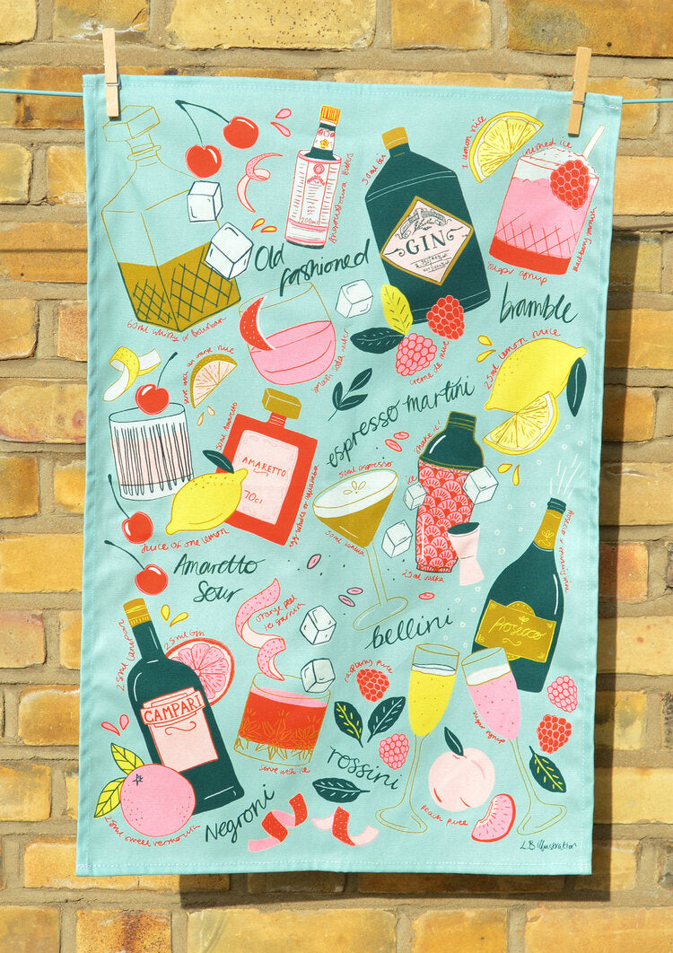 Cocktail party tea towel or kitchen towel hung in front of brick wall 