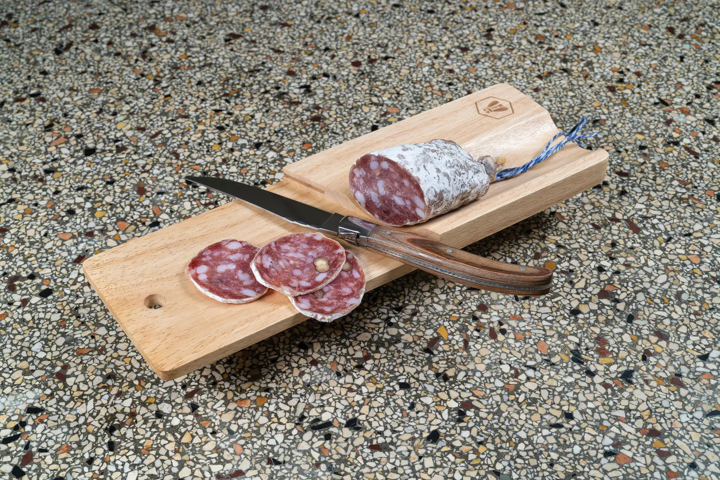 Wooden Board and Knife set with cured sausage on it 
