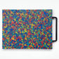 Rainbow cutting board that looks majority blue but has primary color confetti throughout. Handle is black. 