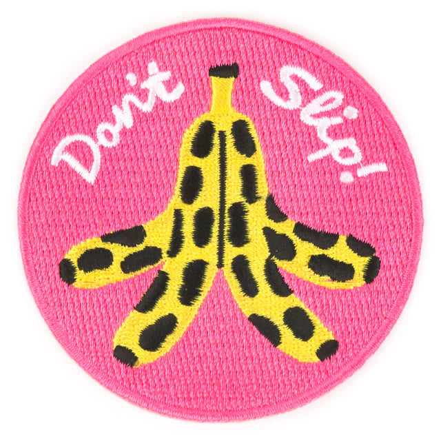 Pink iron on patch that reads "Don't slip!" and has an image of a peeled, spotty banana
