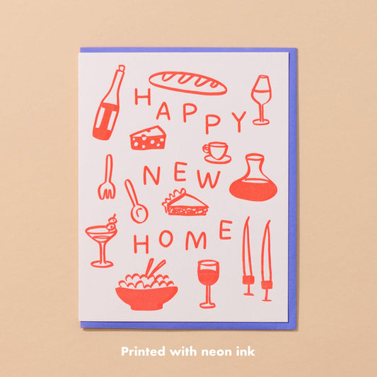 Card reads "Happy New Home" surrounded by food and drink illustrations printed in neon red ink.