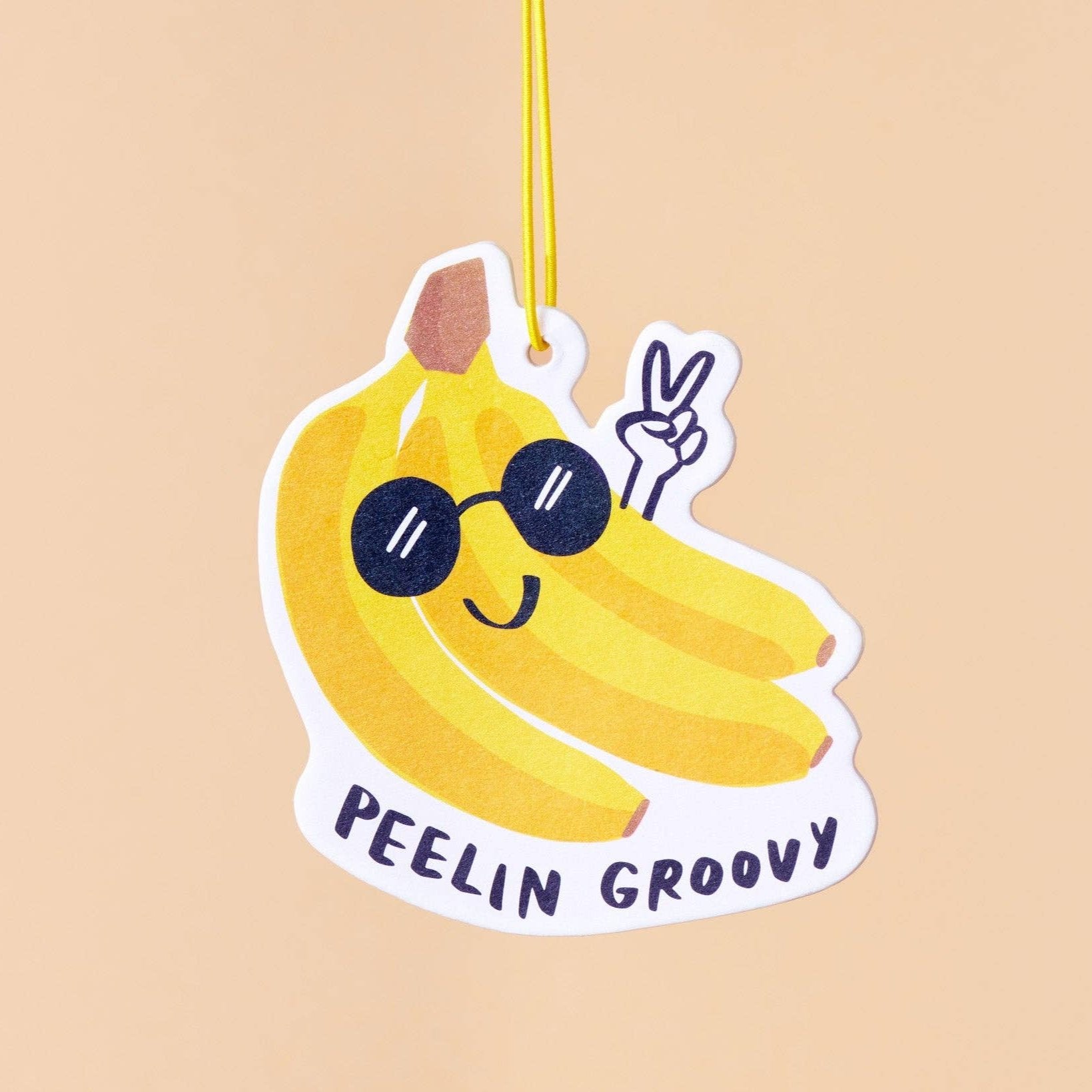 bunch of bananas air freshener with sunglasses on and text below that reads "Peelin Groovy" - banana scented 