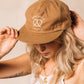 Tan colored, cotton twill, vintage style cap -- embroidered on front it reads "Don't get it twisted" with a pretzel 