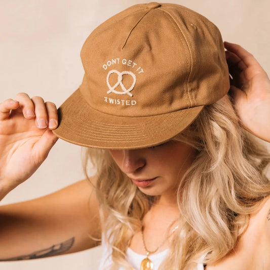 Tan colored, cotton twill, vintage style cap -- embroidered on front it reads "Don't get it twisted" with a pretzel 