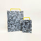Small black and white cutting board w/yellow handle 