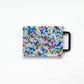 Small confetti cutting board w/black handle