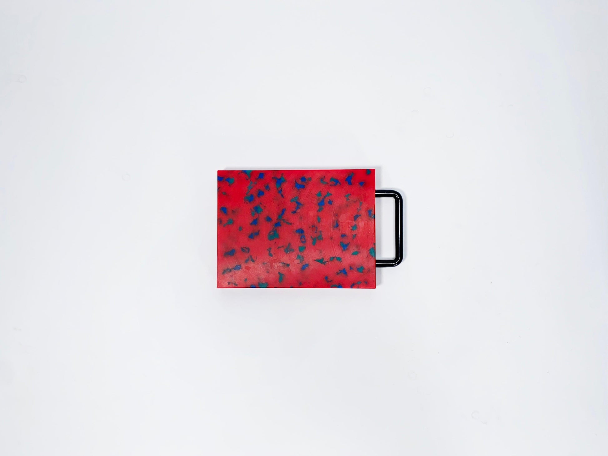 Small red w/blue confetti cutting board w/black handle