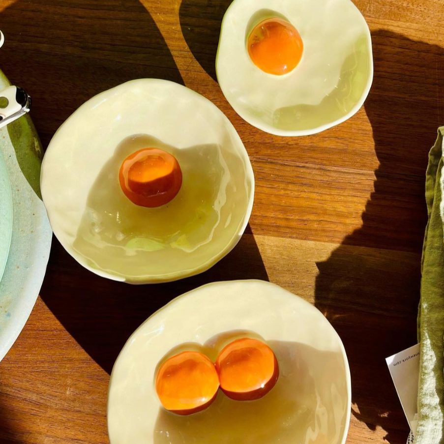 Handmade egg saucers and bowls with both one and two yolks 