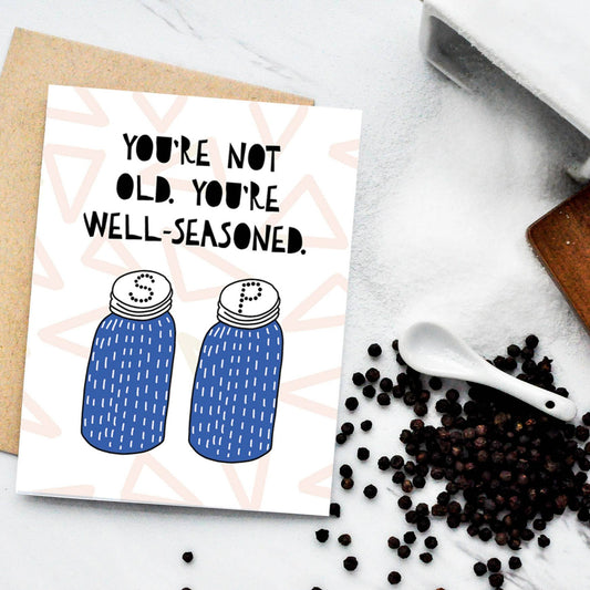 Greeting card with salt and pepper shakers on it that reads "You're not old, You're well-seasoned" 