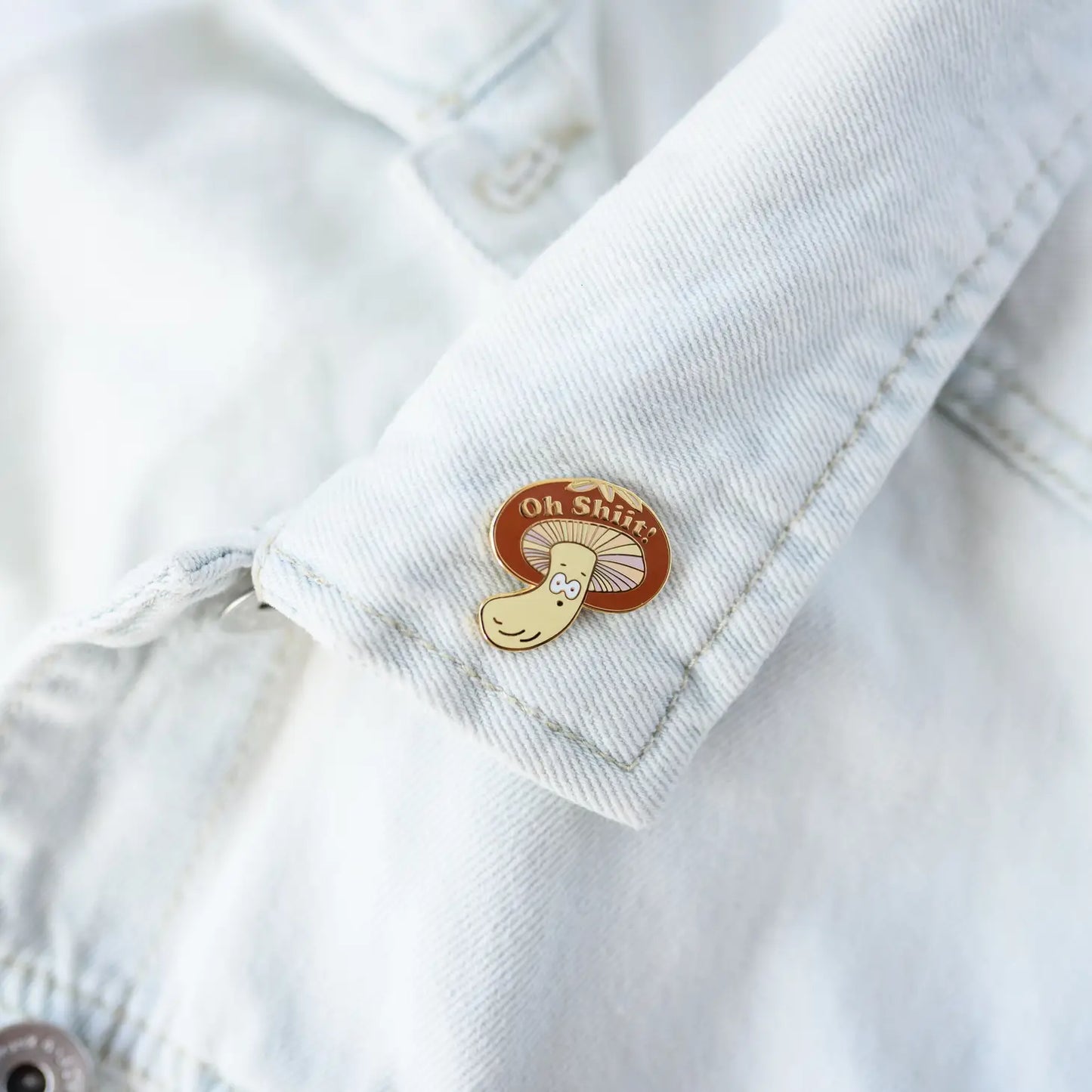 Mushroom enamel pin -- image is a shiitake mushroom with it's mouth open. On the mushroom cap it reads "Oh Shiit!" 