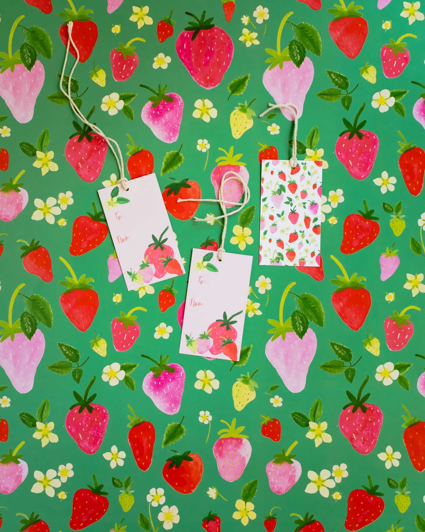 Strawberry gift tags on matching sheet of strawberry wrapping paper 