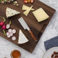 Single cheese knife on board with various cheeses