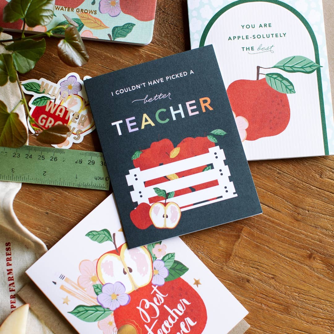 Reads "I couldn't have picked a better teacher" with hand drawn apples in a farmhouse crate and sweet colors. 