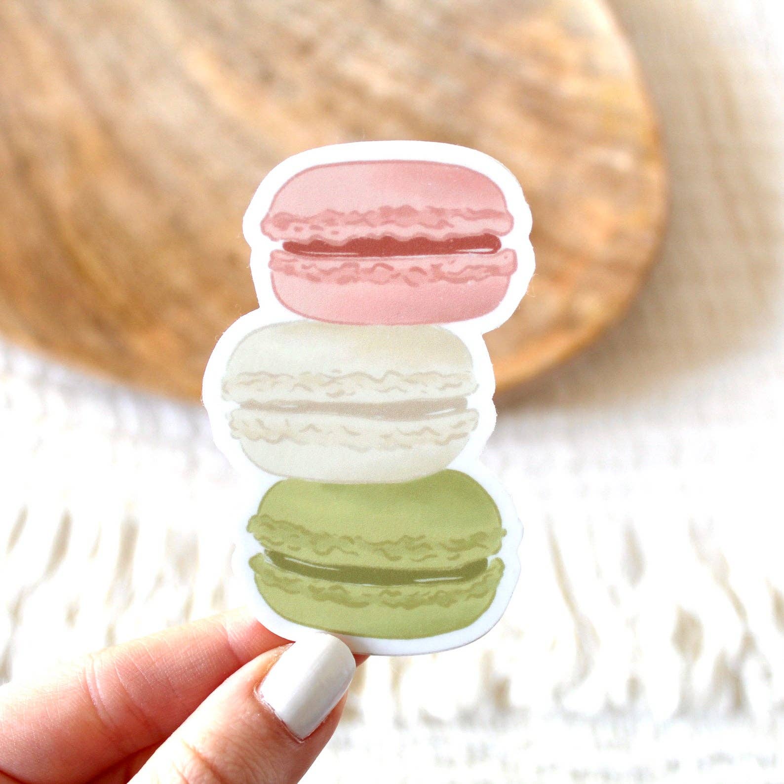 Sticker with 3 macarons stacked on top of each other -- top to bottom: pink, white and green 