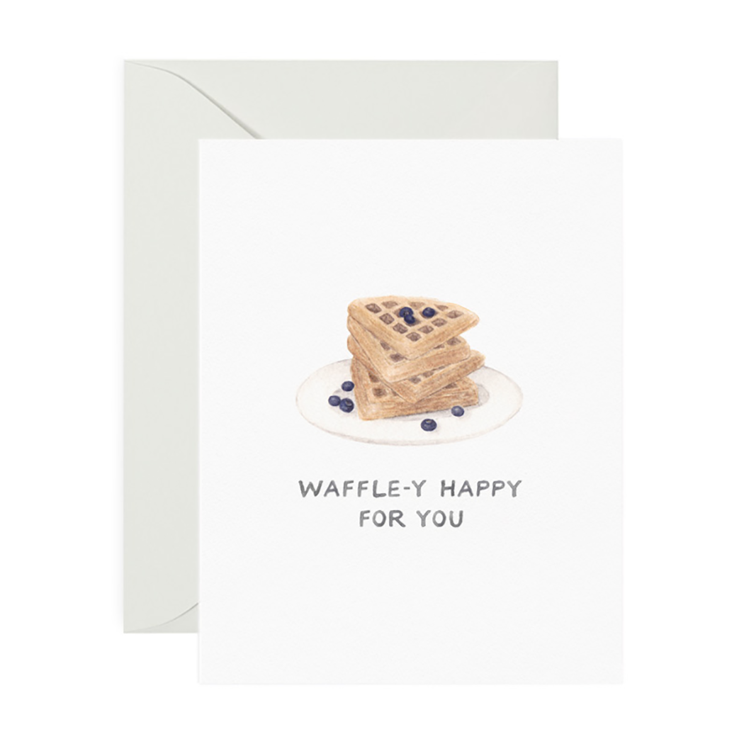 Greeting card that reads "Waffle-y Happy for You" with a stack of triangular waffles and blueberries sprinkled on top.
