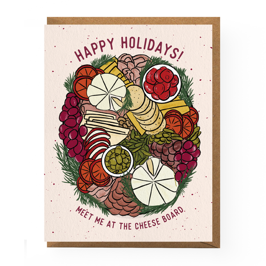 Greeting card with text on top "Happy Holidays!" and text on bottom "Meet me at the cheese board." Illustration on center of card features a cheese and charcuterie board with festive green herbs around the edges.