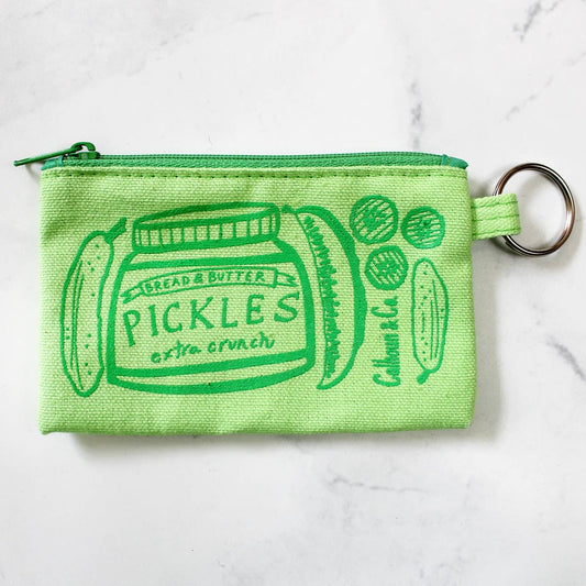 Green pouch with green zipper -- printed on pouch in green ink are whole pickles, pickle spears, bread and butter pickles along with a jar that reads "Bread & Butter Pickles extra crunch" -- comes with attached keyring 