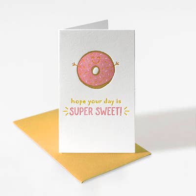 Mini letterpress enclosure card with a pink frosted donut and sprinkles. The text reads "hope your day is super sweet!"