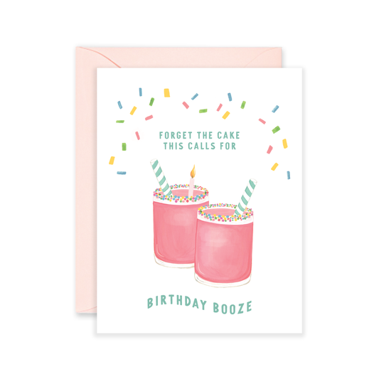 Greeting card with text "Forget the cake... This calls for Birthday Booze" and illustration of two pink straight-sided cocktail glasses with colorful sprinkles on the rim and striped straws. One glass has a single lit birthday candle inside. Text is in blue, surrounded by colorful sprinkles and white background.