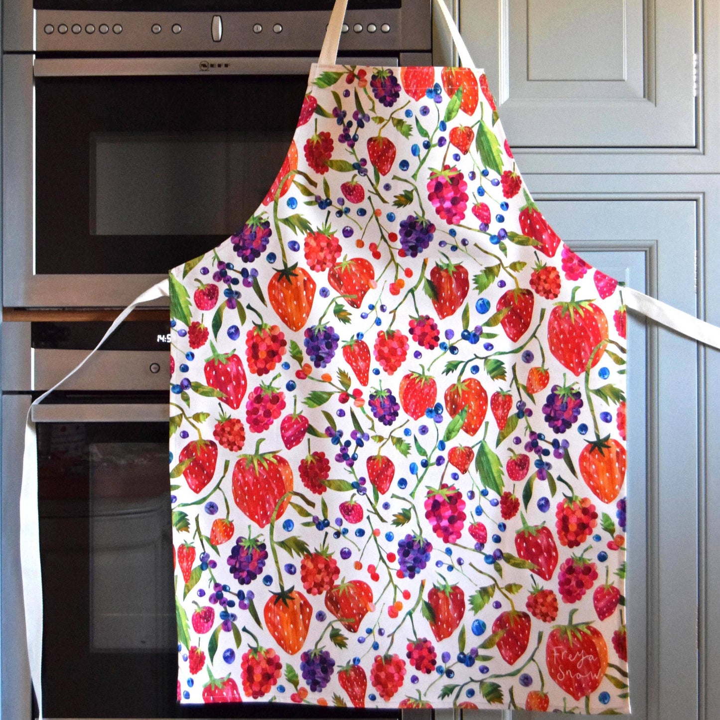 White apron designed with different berries