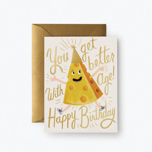 Birthday card with illustration of a happy wedge of cheese wearing white sneakers and a pointy gold birthday hat. Text reads "You get better with age! Happy Birthday!"