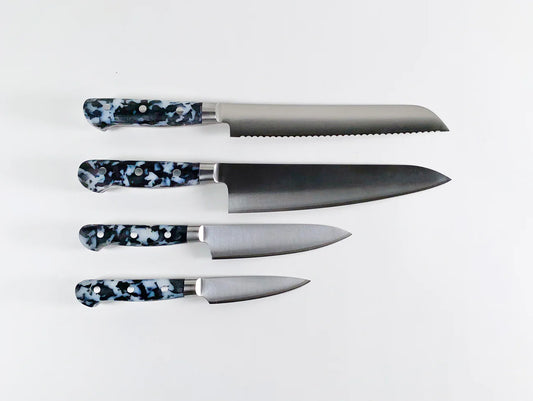 4 different knives all with black and white speckled handles 