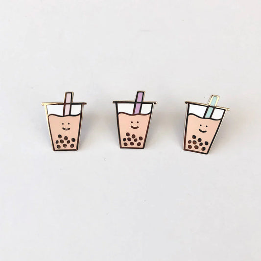 Three separate boba pins with different colored straws