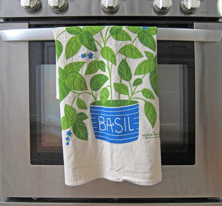 Basil plant dish towel by The Neighborgoods hanging on oven 
