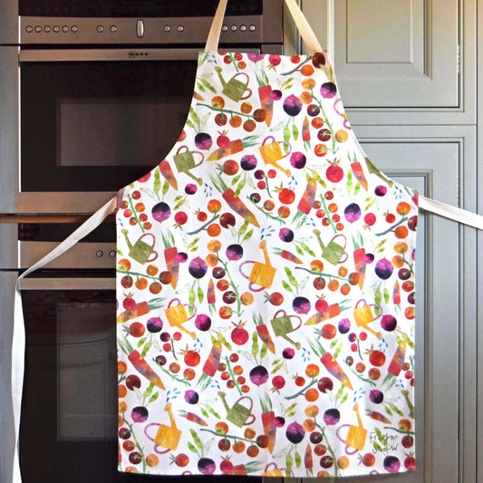 Adult size apron with various garden vegetables and watering cans on it 