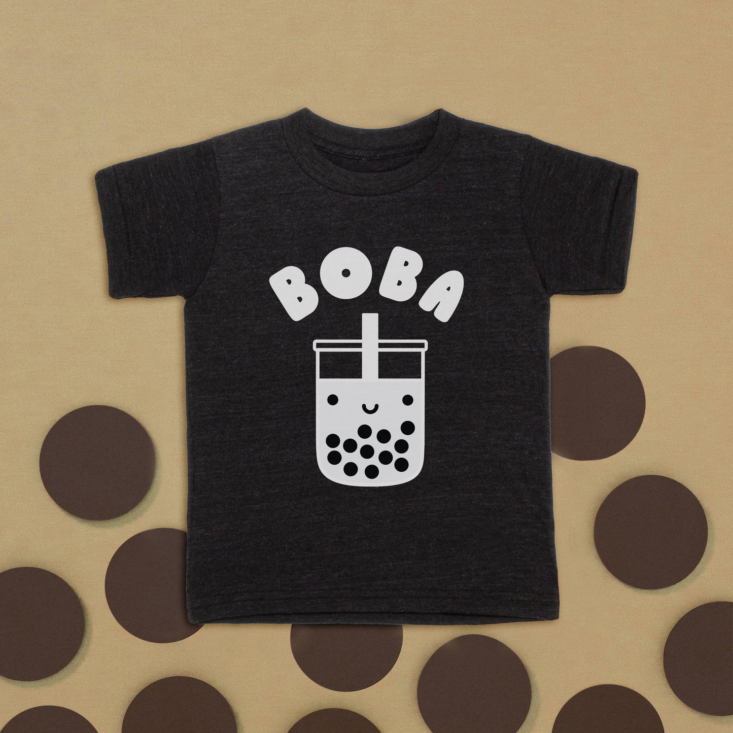 Black boba t-shirt for kids. Says boba across the chest with a smiley boba cup image. All in white ink 