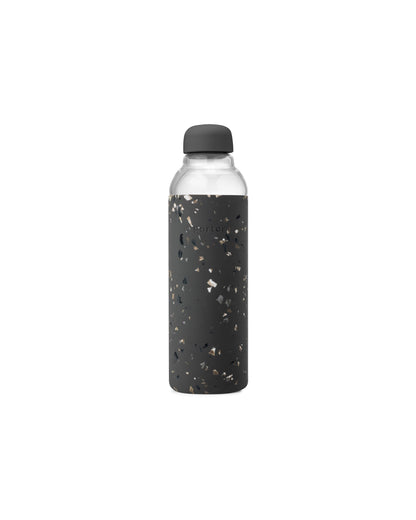Glass reusable water bottle with terrazzo print silicone wrapped around for design and grip