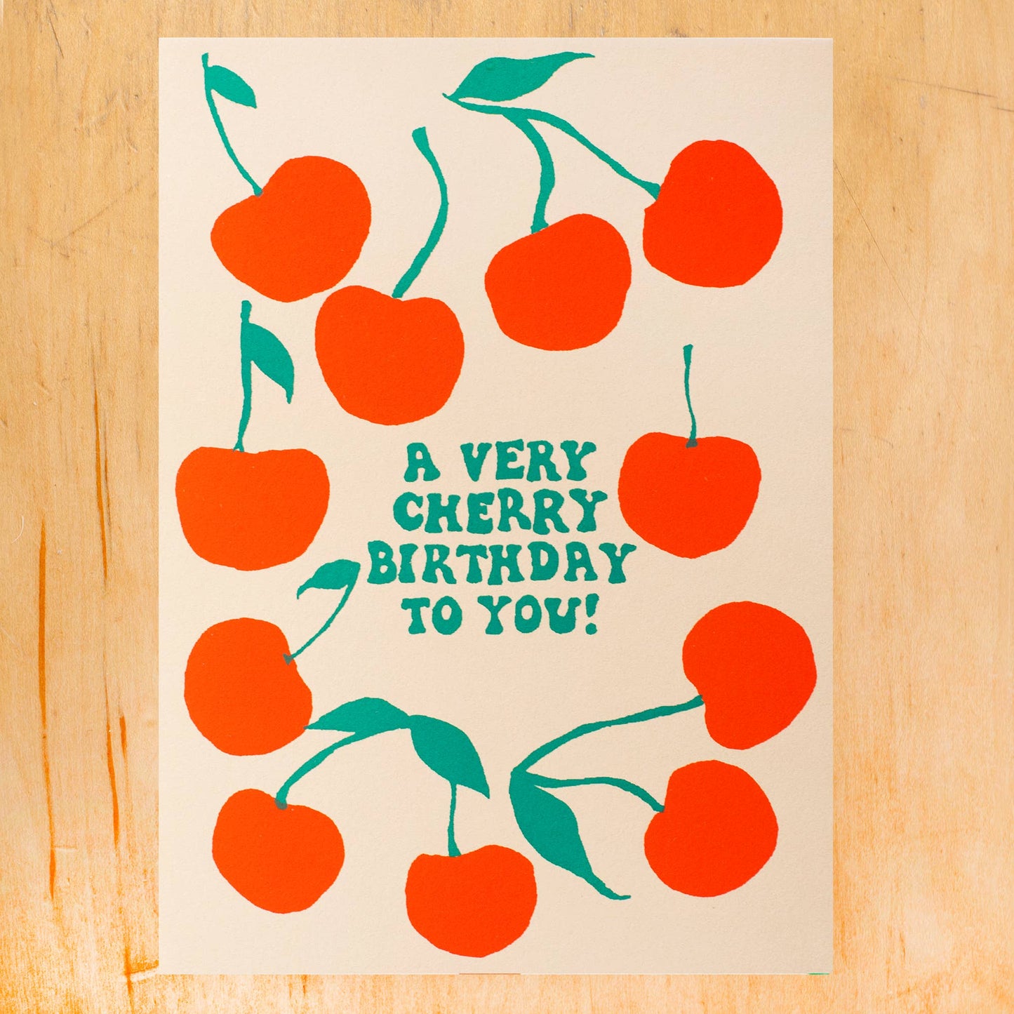 Birthday card that reads "A very cherry birthday to you!" and has red cherries all over