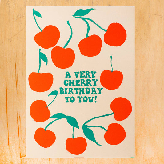 Birthday card that reads "A very cherry birthday to you!" and has red cherries all over