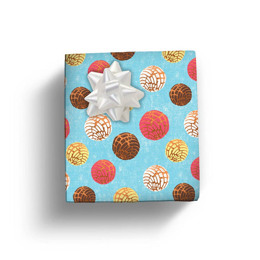 Present to show of the Concha gift wrap with a white bow.