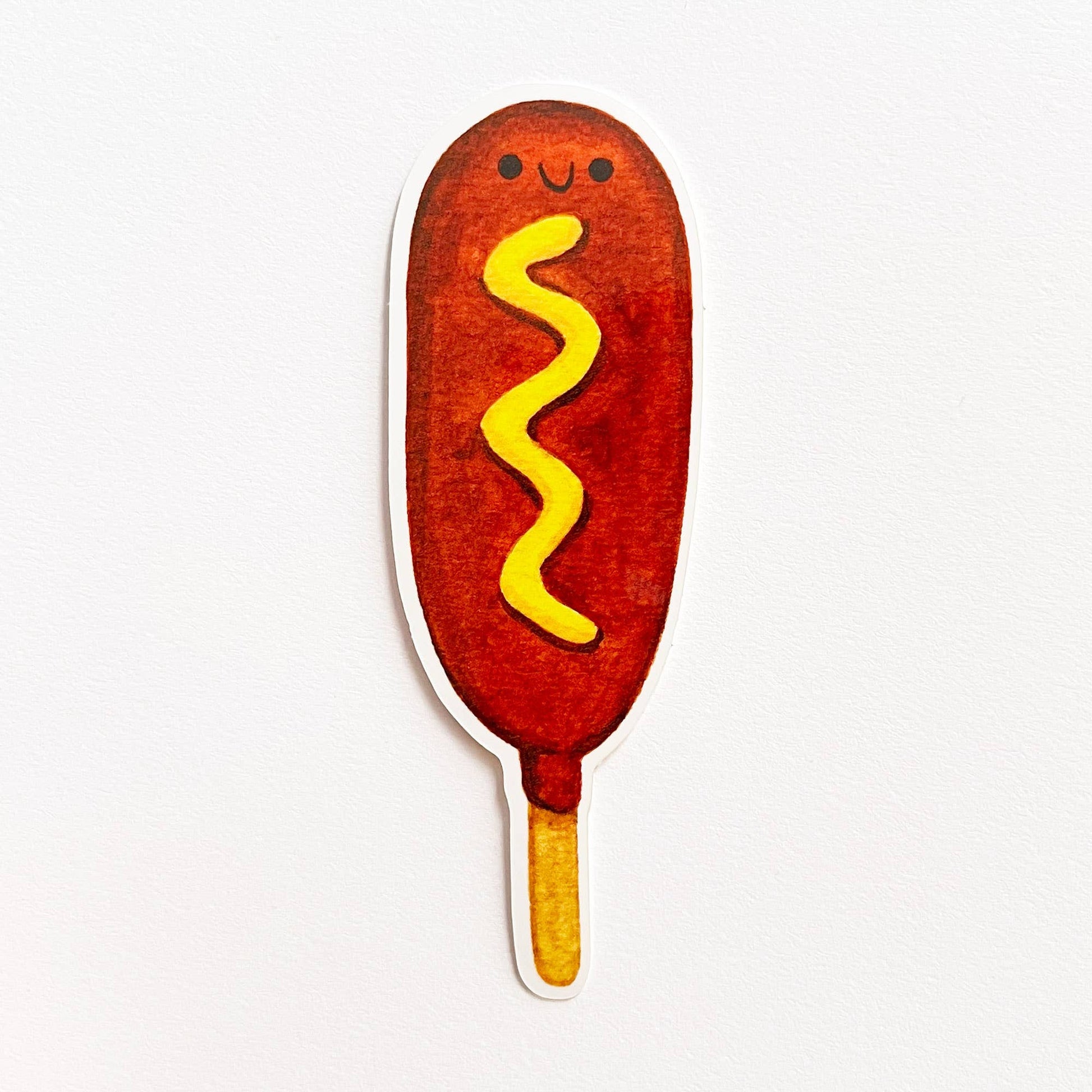 Corndog sticker with some mustard 