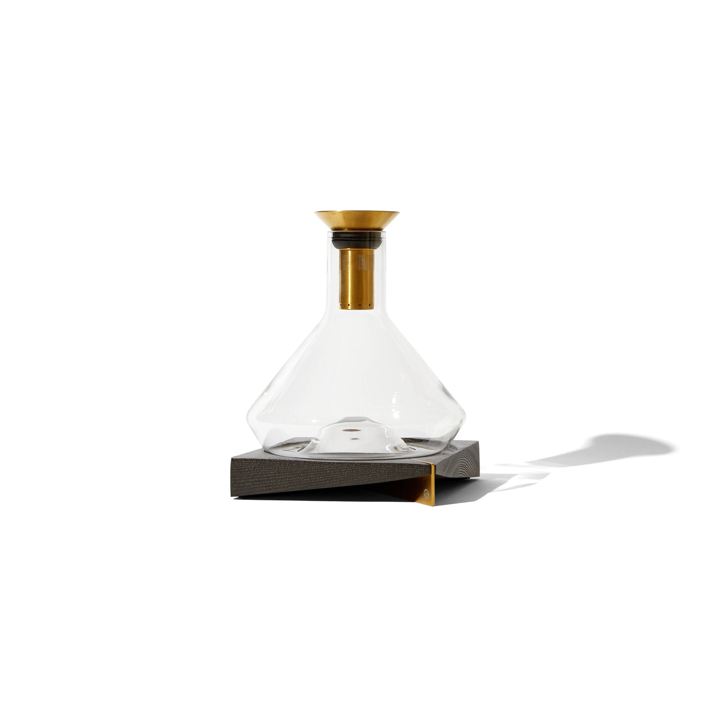 modern, geometric decanter with brass colored, stainless steel accents. Includes base for it to be displayed.  