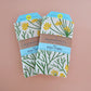 Dill plant dish towel by The Neighborgoods in packaging 