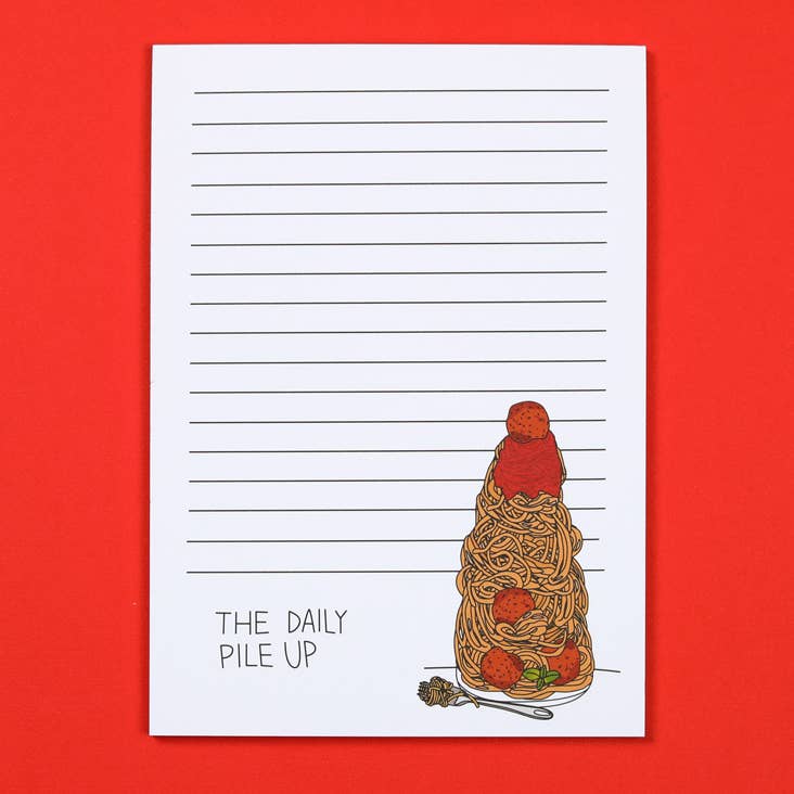Lined notepad with illustration of extra tall pile of spaghetti and meatballs with text "The Daily Pile Up" on the bottom.