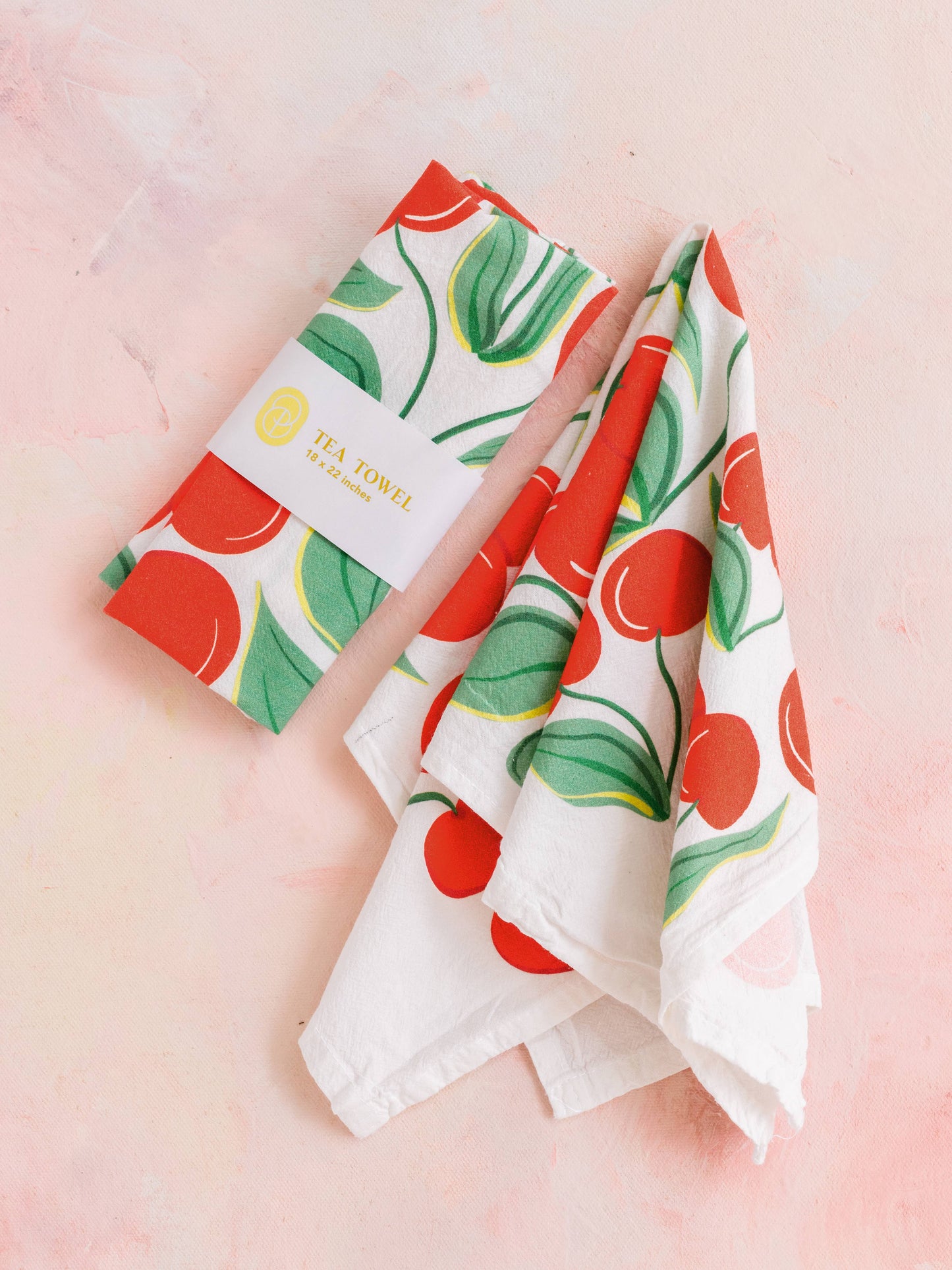 white kitchen or tea towel with red cherries on them 