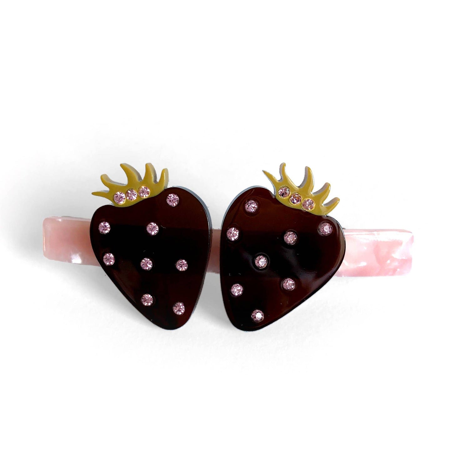 Hair barrette -- two black, translucent strawberries on a pearlescent pink post. 