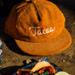 Tan colored, corduroy cap with "Tacos" chainstitched on the front 