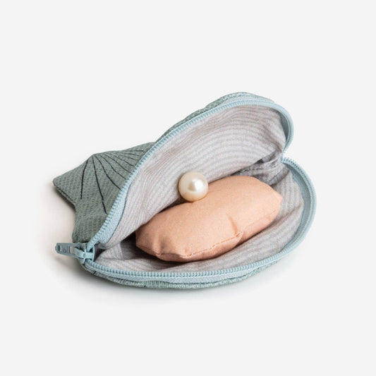 Interior of oyster zippered pouch with fake pearl inside
