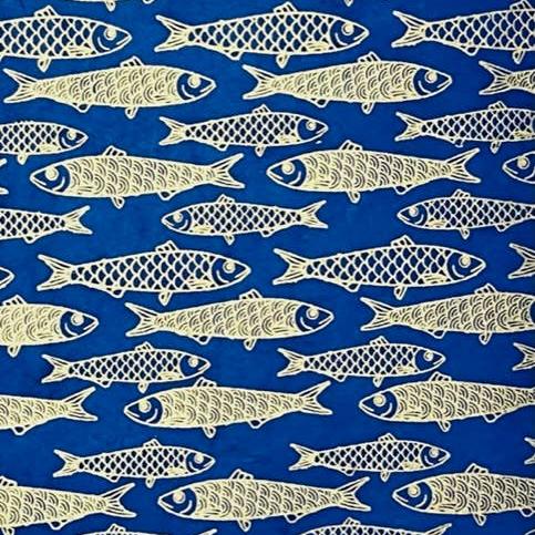 Single sheet of dark blue/indigo gift wrap with gold foil fishes as the design 