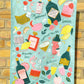 Cocktail party tea towel or kitchen towel hung in front of brick wall 