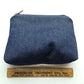 Back denim exterior of hand sewn zippered pouch 